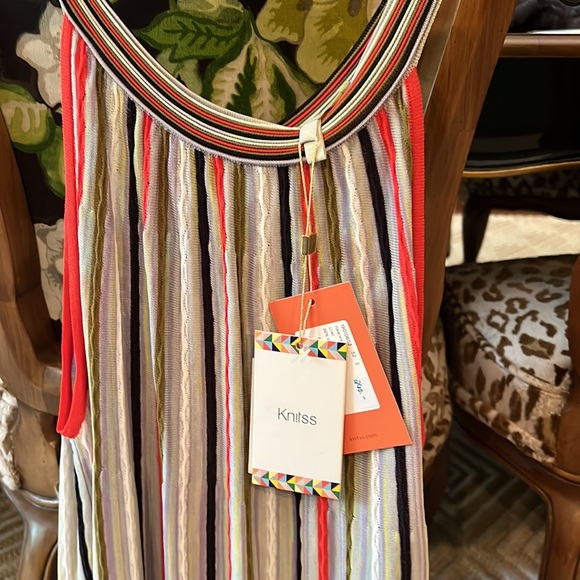 Lightweight knit sleeveless colorful top with attractive gold button at back. - Picture 2 of 5